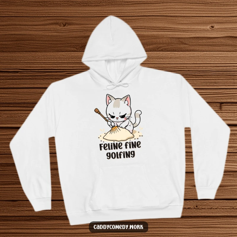 Funny, warm hoodie featuring a cat meticulously raking a sand trap, ideal for a focused, humorous vibe.